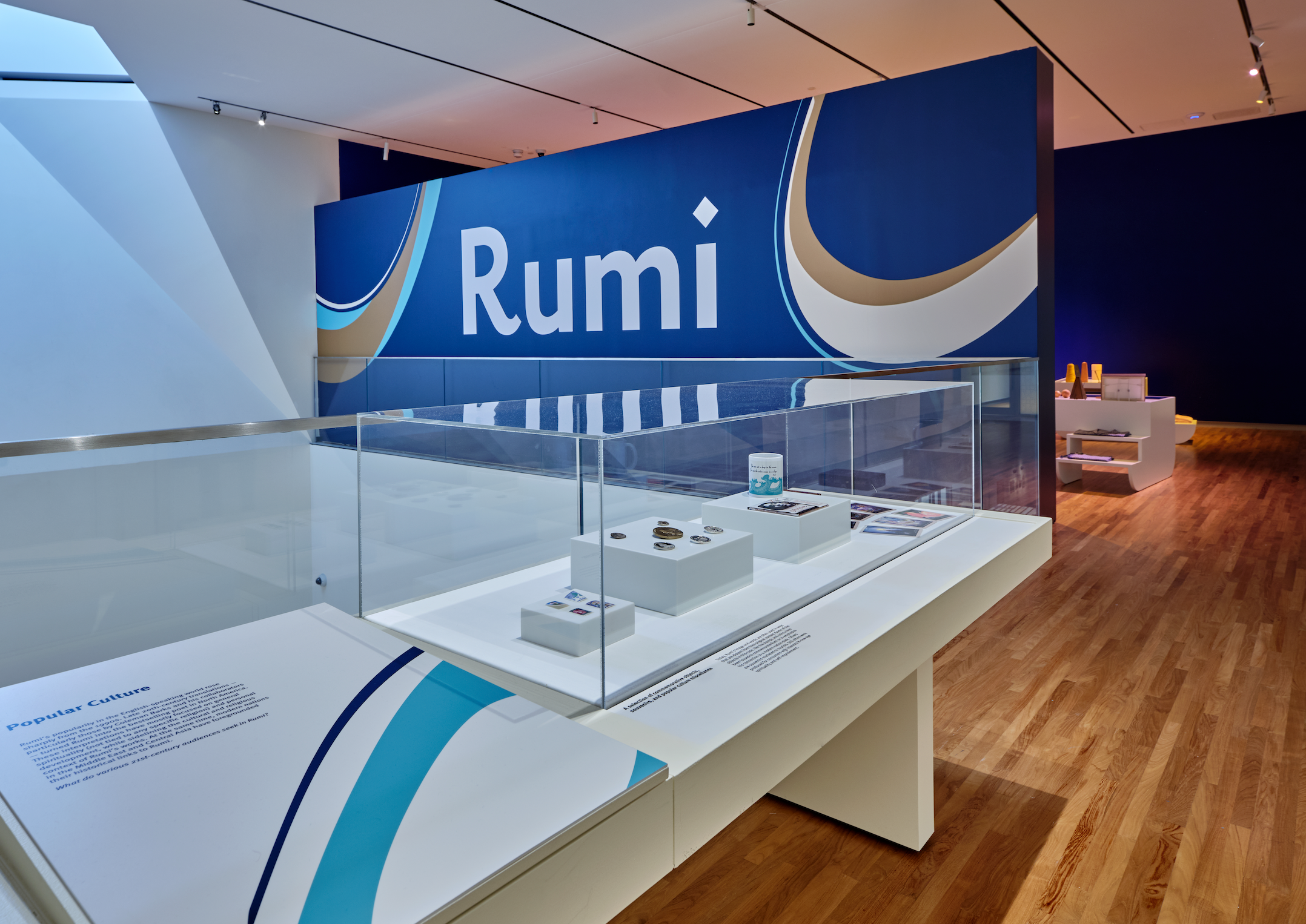 Rumi-inspired items on display with the exhibition's banner on the background that says 