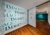 Viewing down a hallway in the Image exhibition at the Aga Khan Museum, with printed wording on the wall and and information wall down the hall